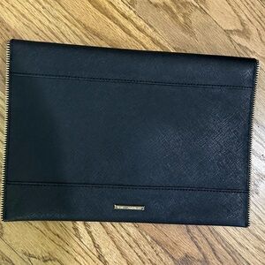 Black Rebecca Minkoff Cluth with gold faux zipper details